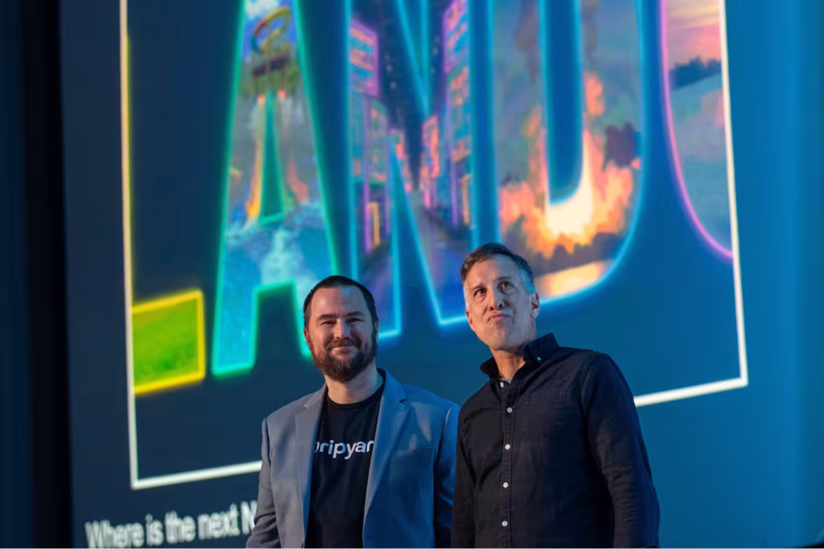 Mike Herchel and Mike Anello on stage in front of a big screen that is saying “Orlando”